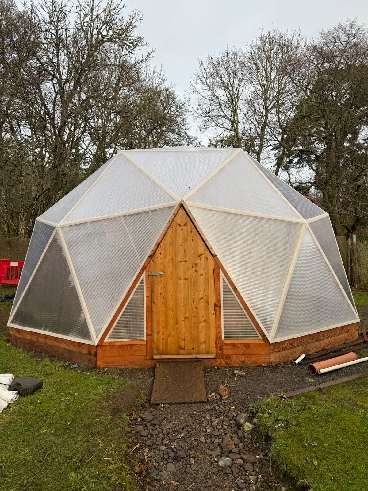 Abundant tomato and cucumber harvest inside a Highland Domes geodesic greenhouse